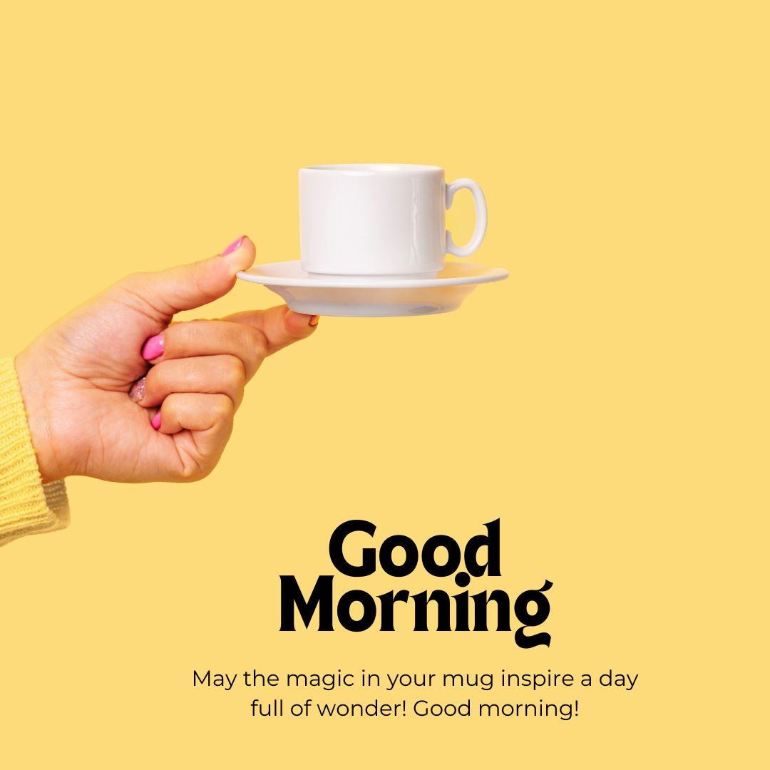 A hand with painted nails holds a white coffee cup and saucer against a bright yellow background. Below, text reads: "Good Morning. May the magic in your mug inspire a day full of wonder! Good morning!" Perfect for those seeking romantic good morning coffee images to start the day right.