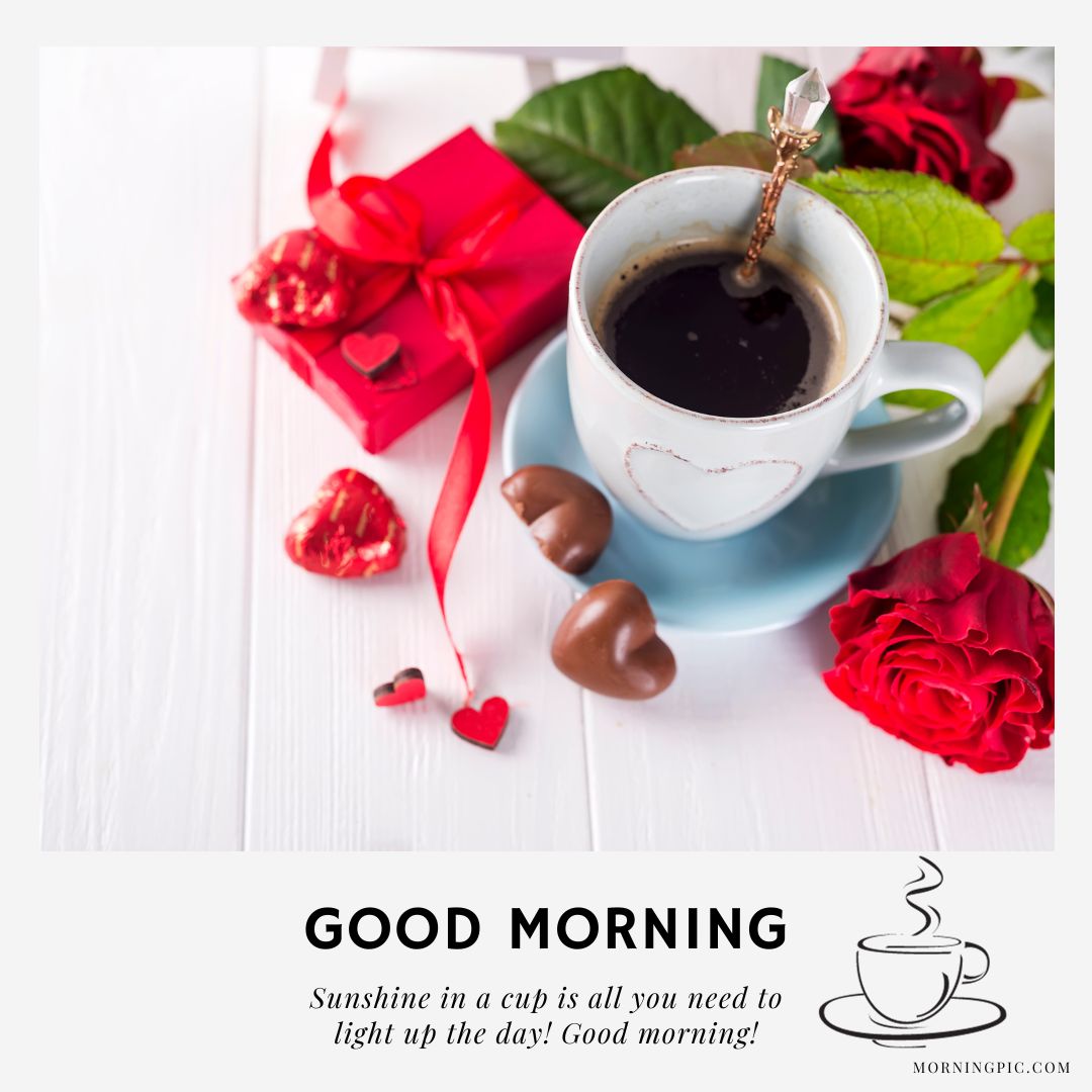 A cup of coffee with a heart-shaped handle on a saucer sits beside chocolate hearts, a red rose, and red gift boxes with ribbons on a white wooden surface. The image has a "Good Morning" message and a coffee cup icon at the bottom, making it perfect for good morning coffee pictures.