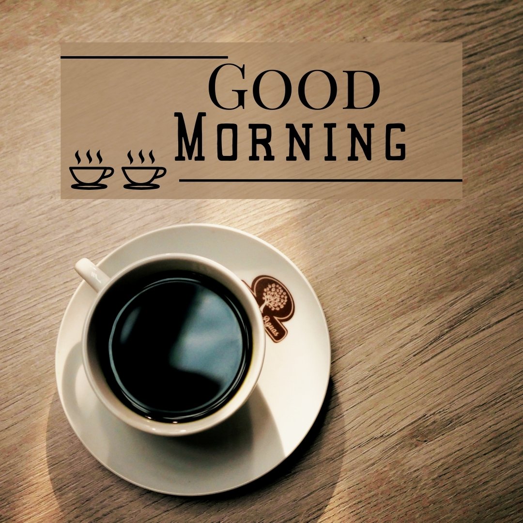A cup of black coffee sits on a white saucer with a logo, placed on a wooden table. The text overlay reads, "Good Morning" with two coffee cup icons. This image is a classic example of good morning coffee images.