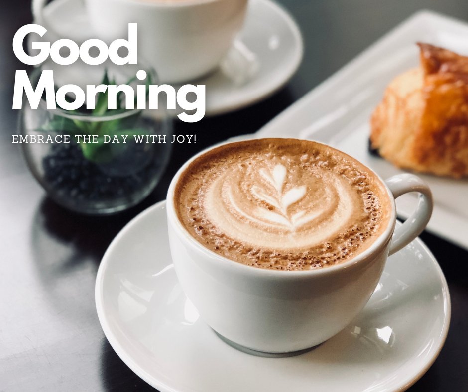 A cup of coffee with latte art sits on a white saucer next to a pastry on a plate, with another cup of coffee and a small plant in the background. The text overlay reads, "Good Morning. Embrace the day with joy!" This image is a delightful example of good morning coffee images.