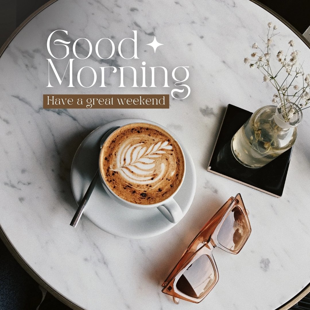 A latte with beautiful latte art sits on a marble table next to a pair of sunglasses and a small vase with flowers. The text overlay reads, "Good Morning. Have a great weekend." This image is an elegant representation of good morning coffee images.