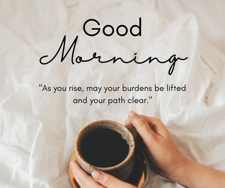 Good morning blessings image showing a person holding a rustic clay mug of coffee in bed, with crisp white linens and a 'Good Morning' greeting, accompanied by a quote about burdens lifting and paths clearing.